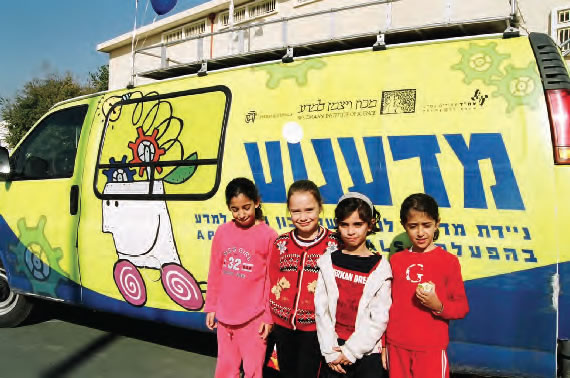 Children in front of the Science Mobile, which has been supported by Applied Materials, the Kennedy Leigh Charitable Trust, and the Naomi and Nehemia Cohen Foundation.